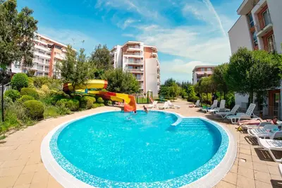a swimming pool with a slide and a playground at Imperial and Crown Fort Noks Grand Resort in Sveti Vlas