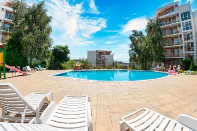 a swimming pool with chairs and a slide at Imperial and Crown Fort Noks Grand Resort in Sveti Vlas