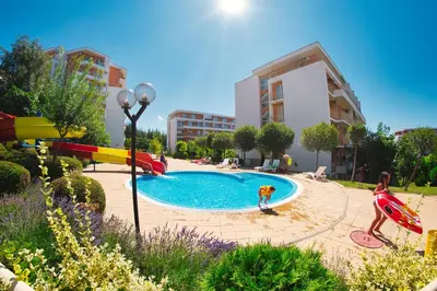 a child playing in a swimming pool in a park at Imperial and Crown Fort Noks Grand Resort in Sveti Vlas