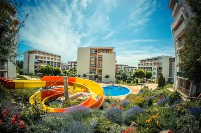 a resort with a pool and a slide at Imperial and Crown Fort Noks Grand Resort in Sveti Vlas