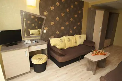 a living room with a couch and a table at Hotel Kotva - All Inclusive in Sunny Beach