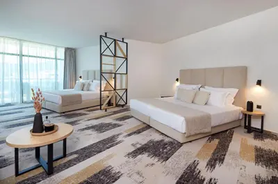 a bedroom with two beds and a large window at Hotel Marvel All Inclusive - FULLY RENOVATED FREE Beach Access in Sunny Beach