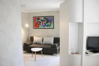 a living room with a couch and a tv at Hotel Perfect in Varna City