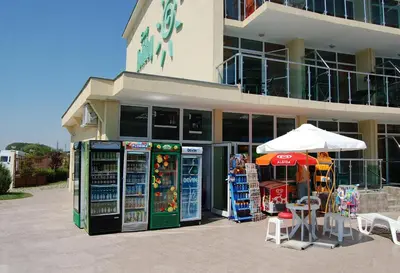 a store with two vending machines in front of a building at Julia Family Apartments in Sunny Beach