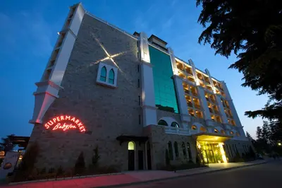 a building with a neon sign in front of it at Art Hotel Babylon in Sunny Beach