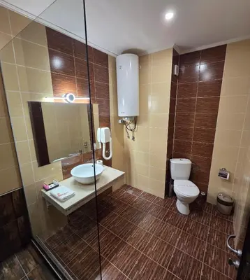a bathroom with a toilet and a sink and a shower at Art Hotel Babylon in Sunny Beach