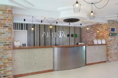 a bar in a room with a brick wall at Hotel Aktinia - All Inclusive in Sunny Beach