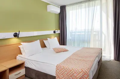 a hotel room with a bed and a window at Hotel Aktinia - All Inclusive in Sunny Beach