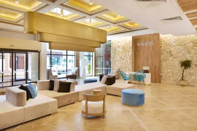 a lobby with couches and chairs in a mall at Hotel Nobel Ultra All Inclusive - FREE Beach Access in Sunny Beach