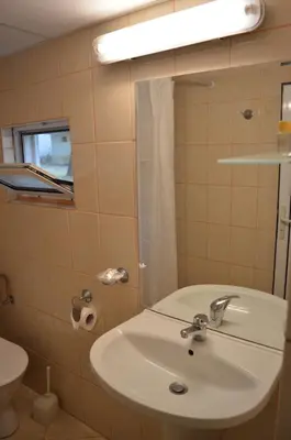 a bathroom with a sink and a mirror and a toilet at Villas Holidays in Primorsko