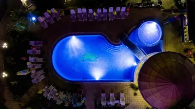 an overhead view of a swimming pool at night at Hotel Sunny in Sozopol