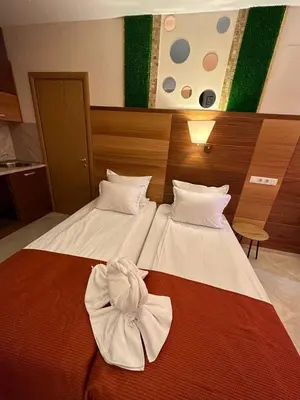 a hotel room with two beds with a bow on them at Briz Beach apartments - section B in Sunny Beach