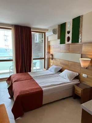 a bedroom with a large bed and a window at Briz Beach apartments - section B in Sunny Beach