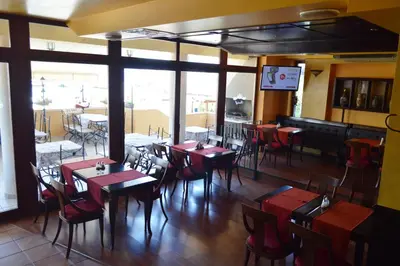 a restaurant with tables and chairs in a room at Stankoff Hotel in Nesebar