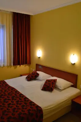 two beds in a hotel room with two pillows at Stankoff Hotel in Nesebar