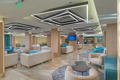 a lobby of a hospital with couches and chairs at Hotel Pomorie Sun - All Inclusive in Sunny Beach