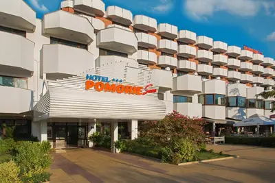 a large white building with a sign on it at Hotel Pomorie Sun - All Inclusive in Sunny Beach