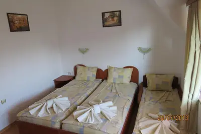 a bedroom with two beds with bows on them at Hotel Strinava in Primorsko