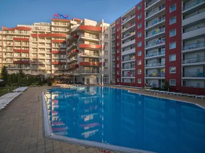 a swimming pool in front of some apartment buildings at Hotel Fenix - All Inclusive in Sunny Beach