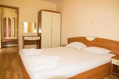 a bedroom with a large white bed with two pillows at Elite Apartments in Sunny Beach