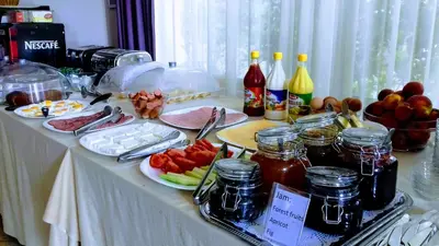 a table with food and drinks and fruit on it at Hotel Diamanti in Sozopol