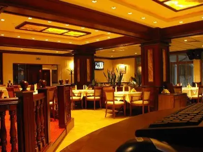 a dining room with tables and chairs in a restaurant at Hotel Park in Karnobat