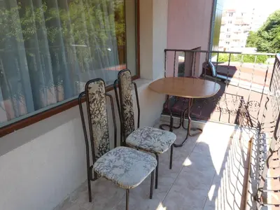 a balcony with two chairs and a table and a window at Hotel Beroe in Sveti Vlas