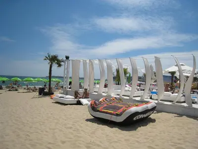 a beach with chairs and a inflatable at Boutique Suites Rainbow 4 in Sunny Beach