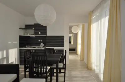 a kitchen and dining room with a table and chairs at Boutique Suites Rainbow 4 in Sunny Beach