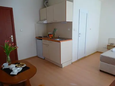 a small apartment with a kitchen and a table at Rainbow 2 Holiday Complex in Sunny Beach
