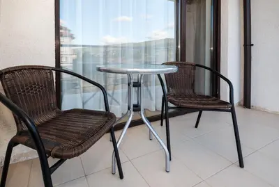 two chairs and a table on a balcony at The chill House in Sunny Beach in Sunny Beach