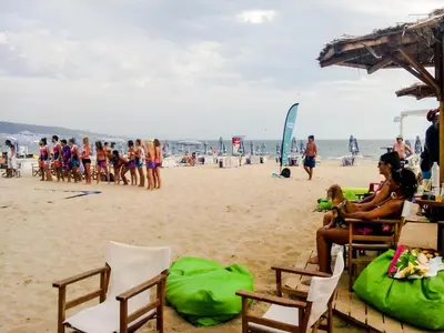 a group of people sitting on the beach at The chill House in Sunny Beach in Sunny Beach