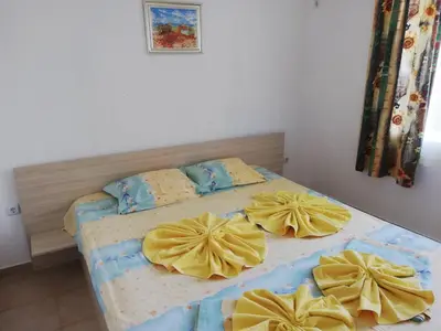 a bedroom with two beds with yellow pillows at Apartments Ivelin in Lozenets
