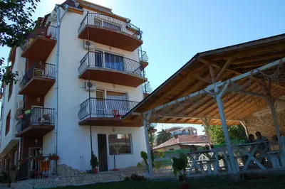 a large white building with balconies on the side of it at Apartments Ivelin in Lozenets