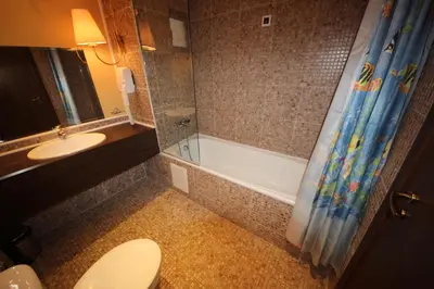 a bathroom with a toilet and a shower and a sink at Menada Apartments in Royal Beach in Sunny Beach