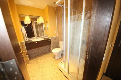 a bathroom with a toilet and a glass shower at Menada Apartments in Royal Beach in Sunny Beach