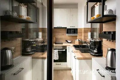 a kitchen with white cabinets and a stove top oven at Cathedral Apartment Varna in Varna City