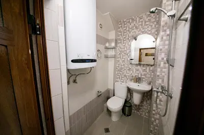 a small bathroom with a toilet and a sink at Cathedral Apartment Varna in Varna City