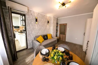 a living room with a table and a couch at Cathedral Apartment Varna in Varna City
