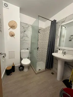 a bathroom with a shower and a toilet and a sink at Complex Sands Holiday Apartments in Sunny Beach