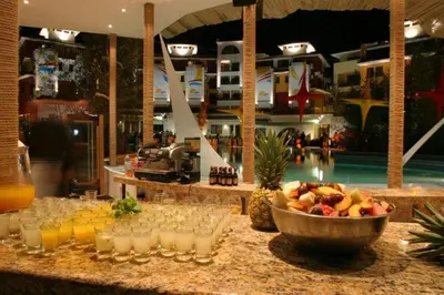 a bar with drinks and a bowl of fruit on a counter at Visit Sunny Beach Marina Apartments in Ravda