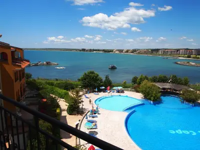 a view of a large swimming pool next to a lake at Visit Sunny Beach Marina Apartments in Ravda