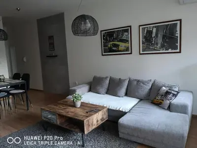 a living room with a couch and a coffee table at Sea Garden Apartment IDM in Varna City