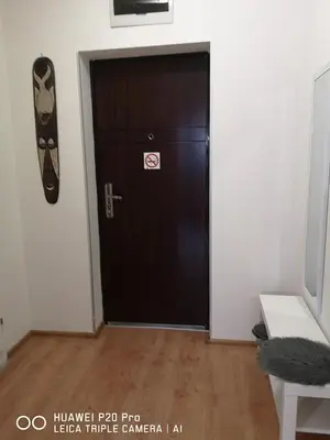 a black door with a sign on it in a room at Sea Garden Apartment IDM in Varna City