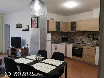 a kitchen with a table and a dining room at Sea Garden Apartment IDM in Varna City