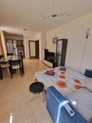 a room with a bed and a living room at Apartment Kalin complex Aurelia-RAVDA in Nesebar