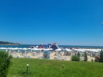 a view of a beach with chairs and umbrellas at Apartment Kalin complex Aurelia-RAVDA in Nesebar