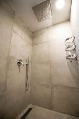 a bathroom with a shower with a ladder in it at The Poolhouse in Sunny Beach