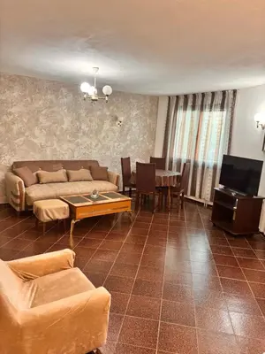 a living room with a couch and a table at Apartments Yana in Obzor