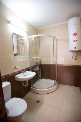 a bathroom with a shower and a toilet and a sink at Complex Apolon in Nesebar